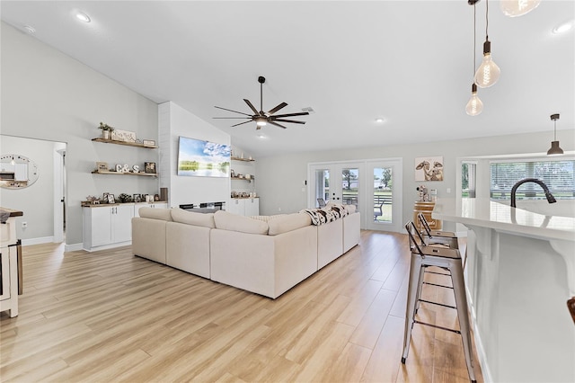 5478 NW 153rd Ct, Morriston, FL 32668 - living room with ceiling fan, light wood-style flooring, high vaulted ceiling, french doors, and recessed lighting