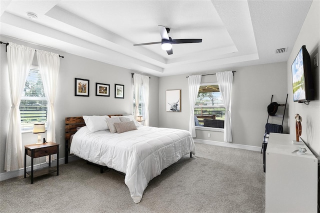 5478 NW 153rd Ct, Morriston, FL 32668 - bedroom featuring a raised ceiling, light carpet, baseboards, and a ceiling fan