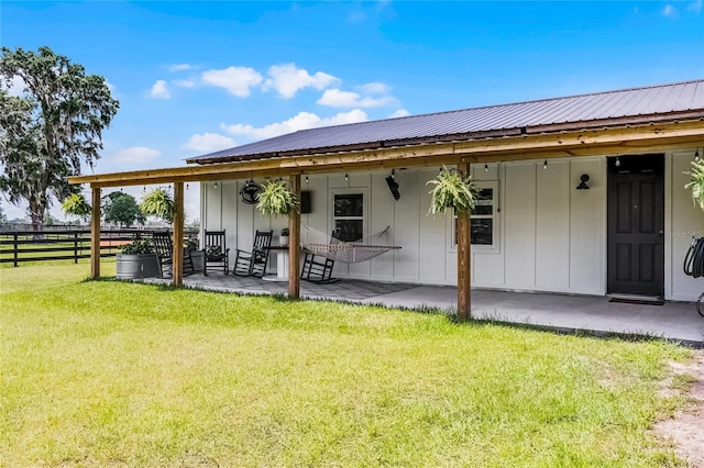 5478 NW 153rd Ct, Morriston, FL 32668 - back of house with board and batten siding, metal roof, and a patio area