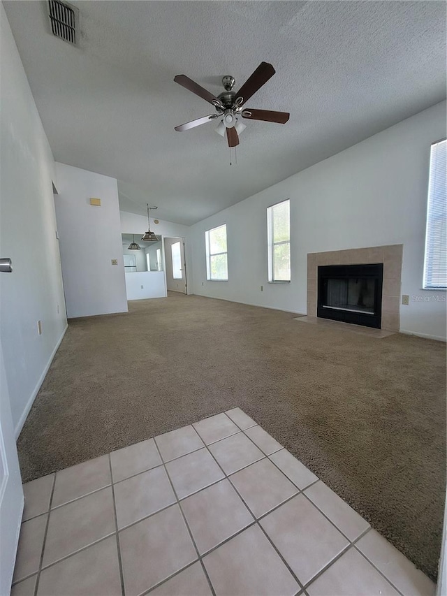 3124 S Semoran Blvd Unit 206, Orlando, FL 32822 - unfurnished living room featuring light colored carpet, a ceiling fan, a fireplace, a textured ceiling, and vaulted ceiling
