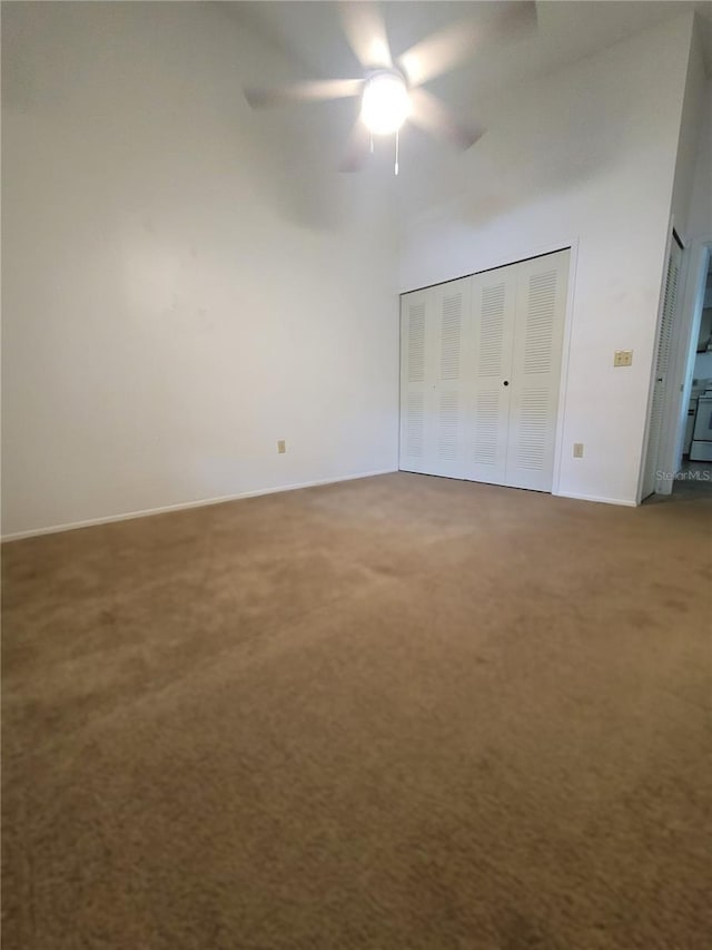 3124 S Semoran Blvd Unit 206, Orlando, FL 32822 - unfurnished bedroom featuring carpet floors, a high ceiling, baseboards, a ceiling fan, and a closet