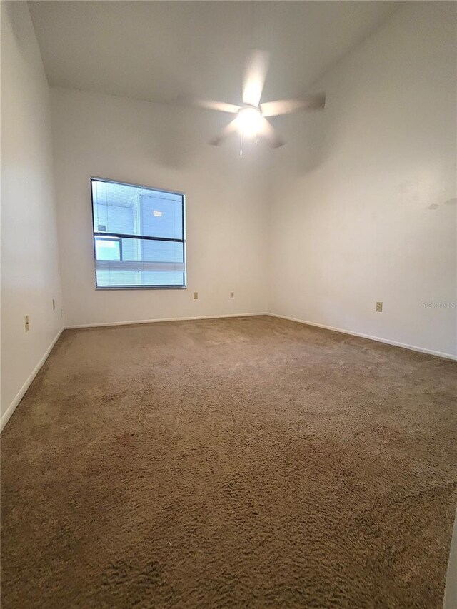 3124 S Semoran Blvd Unit 206, Orlando, FL 32822 - empty room featuring a ceiling fan, carpet flooring, and baseboards