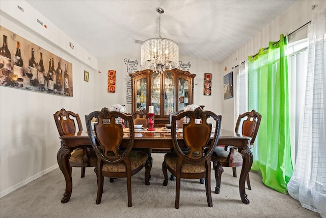 1321 Dunbarton Ct, Kissimmee, FL 34758 - dining area featuring a chandelier, light colored carpet, baseboards, and lofted ceiling