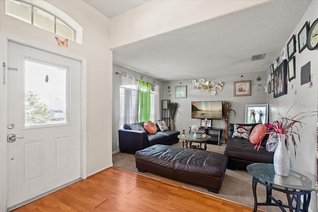 1321 Dunbarton Ct, Kissimmee, FL 34758 - entrance foyer featuring wood finished floors, a textured ceiling, and a chandelier