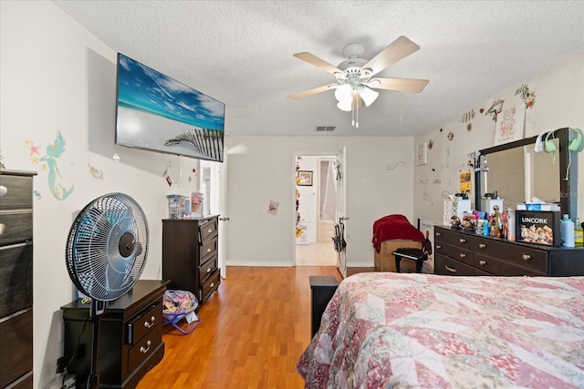 1321 Dunbarton Ct, Kissimmee, FL 34758 - bedroom with light wood finished floors, a textured ceiling, ceiling fan, and baseboards