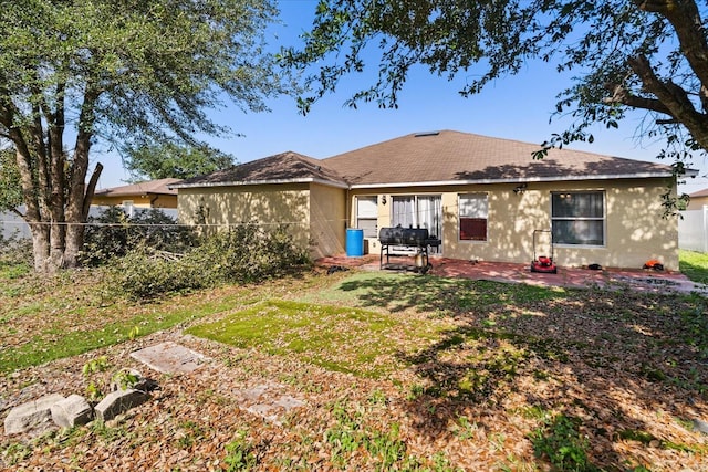 1321 Dunbarton Ct, Kissimmee, FL 34758 - back of house featuring stucco siding, a patio, and a shingled roof