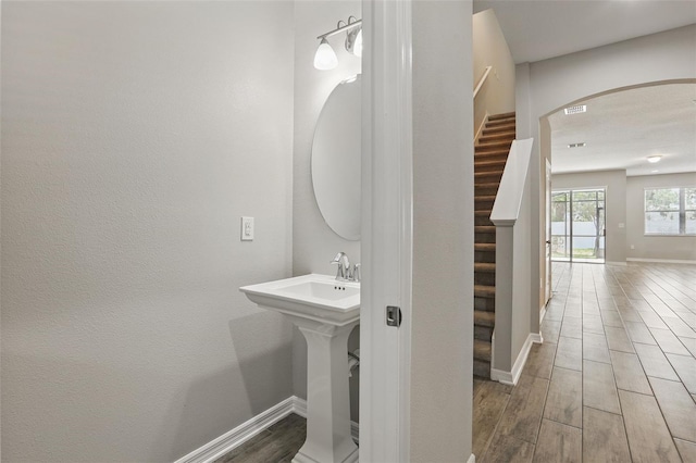 328 Cedar Bark Ln, Sanford, FL 32771 - bathroom with wood finished floors, baseboards, and a sink