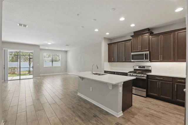 328 Cedar Bark Ln, Sanford, FL 32771 - kitchen with appliances with stainless steel finishes, a sink, baseboards, recessed lighting, and light wood-style flooring