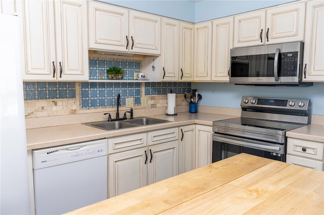 314 Windmeadows St Unit 314, Altamonte Springs, FL 32701 - kitchen with stainless steel appliances, a sink, decorative backsplash, and wooden counters