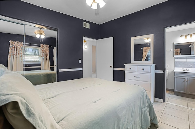 826 Cherokee Cir, Sanford, FL 32773 - bedroom with light tile patterned floors, connected bathroom, a closet, a sink, and a ceiling fan