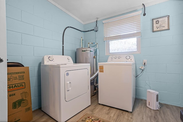 826 Cherokee Cir, Sanford, FL 32773 - laundry room with separate washer and dryer, ornamental molding, light wood-style flooring, water heater, and concrete block wall