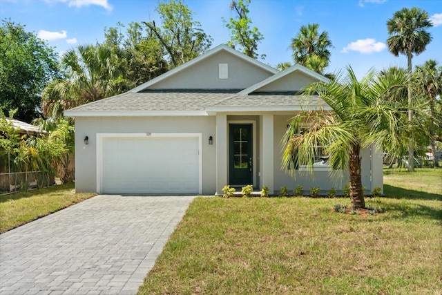 1119 W 7th St, Sanford, FL 32771 - view of front of property with roof with shingles, an attached garage, a front lawn, decorative driveway, and stucco siding