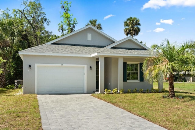 1119 W 7th St, Sanford, FL 32771 - view of front facade featuring a shingled roof, an attached garage, stucco siding, a front yard, and central AC