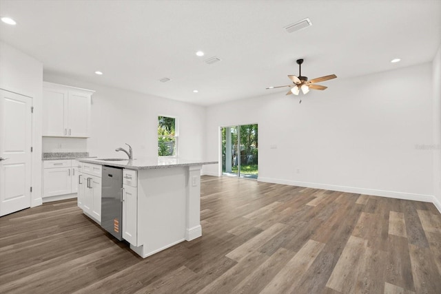 1119 W 7th St, Sanford, FL 32771 - kitchen with dishwasher, wood finished floors, recessed lighting, ceiling fan, and an island with sink