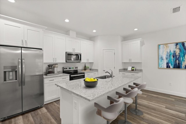 1119 W 7th St, Sanford, FL 32771 - kitchen featuring stainless steel appliances, a sink, white cabinets, dark wood-style flooring, and recessed lighting
