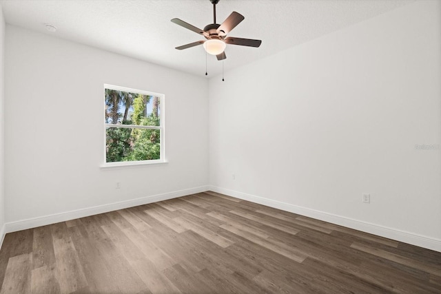1119 W 7th St, Sanford, FL 32771 - spare room featuring dark wood-style flooring, a ceiling fan, baseboards, and a smoke detector