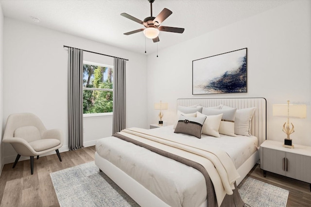 1119 W 7th St, Sanford, FL 32771 - bedroom with light wood-style flooring, baseboards, and ceiling fan