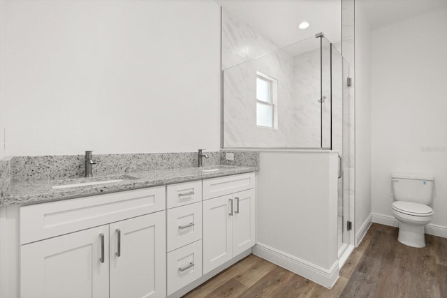 1119 W 7th St, Sanford, FL 32771 - bathroom featuring a stall shower, wood finished floors, double vanity, and toilet