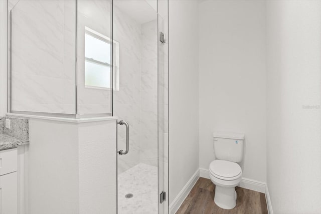 1119 W 7th St, Sanford, FL 32771 - bathroom featuring wood finished floors, toilet, a stall shower, vanity, and baseboards