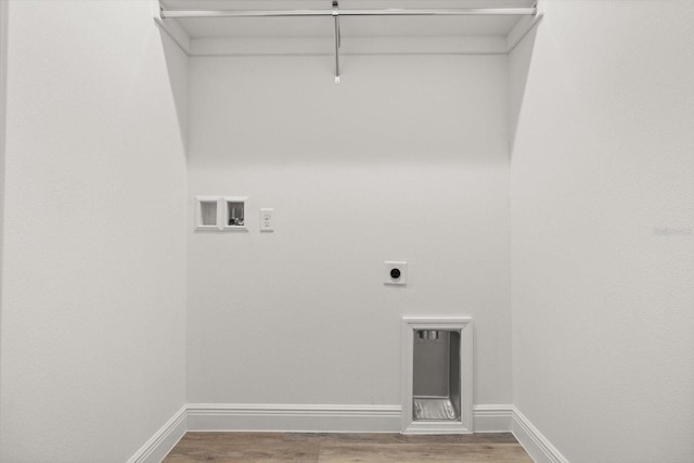 1119 W 7th St, Sanford, FL 32771 - laundry area with electric dryer hookup, washer hookup, wood finished floors, and baseboards