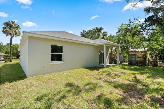 1119 W 7th St, Sanford, FL 32771 - back of property featuring stucco siding and a yard