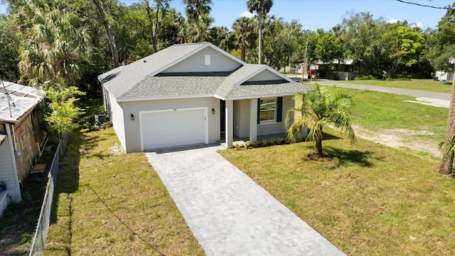 1119 W 7th St, Sanford, FL 32771 - view of front of property with roof with shingles, a garage, decorative driveway, stucco siding, and a front lawn