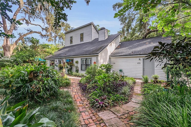1315 E 24th St, Sanford, FL 32771 - rear view of house featuring roof with shingles and a chimney