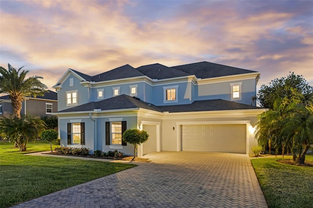 16086 Johns Lake Overlook Dr, Winter Garden, FL 34787 - view of front of property with stucco siding, decorative driveway, a front yard, and a garage