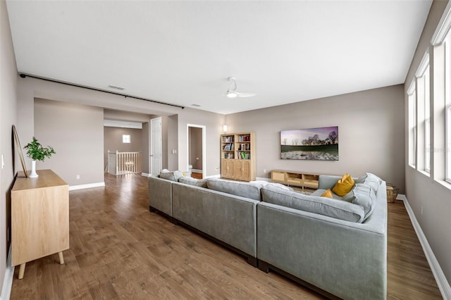 16086 Johns Lake Overlook Dr, Winter Garden, FL 34787 - living room featuring wood finished floors, ceiling fan, and baseboards