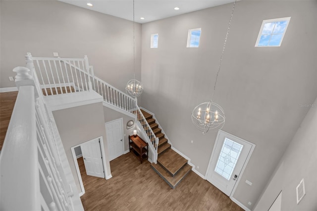 16086 Johns Lake Overlook Dr, Winter Garden, FL 34787 - stairs with a high ceiling, a chandelier, wood finished floors, plenty of natural light, and recessed lighting