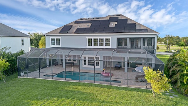 16086 Johns Lake Overlook Dr, Winter Garden, FL 34787 - back of property with a patio, solar panels, a yard, and an outdoor pool