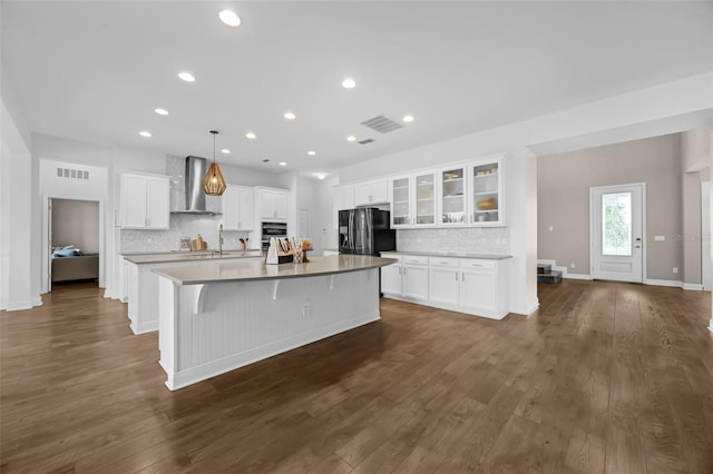 16086 Johns Lake Overlook Dr, Winter Garden, FL 34787 - kitchen featuring wall chimney exhaust hood, oven, decorative backsplash, refrigerator with ice dispenser, and recessed lighting