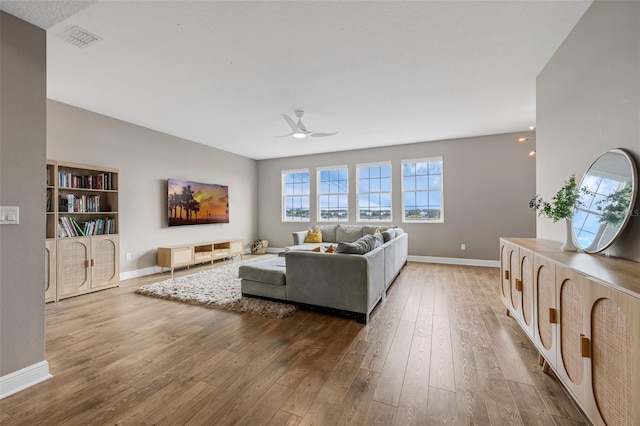 16086 Johns Lake Overlook Dr, Winter Garden, FL 34787 - living room featuring hardwood / wood-style flooring, ceiling fan, plenty of natural light, and baseboards