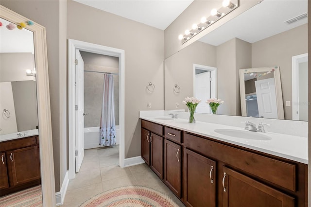 16086 Johns Lake Overlook Dr, Winter Garden, FL 34787 - bathroom with double vanity, tile patterned flooring, shower / tub combo, and baseboards
