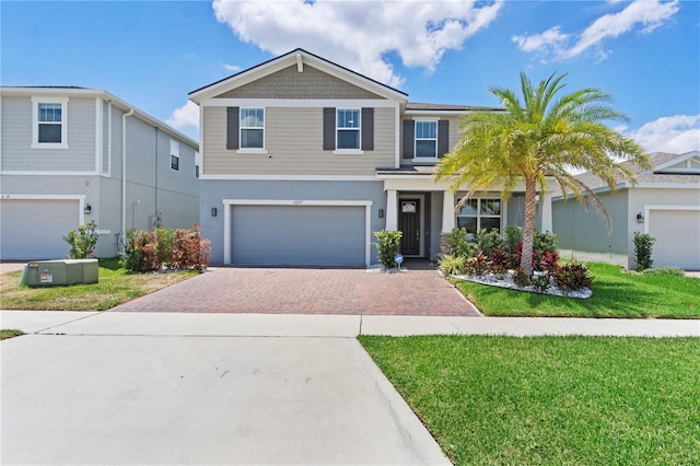 2227 Blue Salvia St, Clermont, FL 34711 - view of front of house featuring decorative driveway, an attached garage, a front lawn, and stucco siding