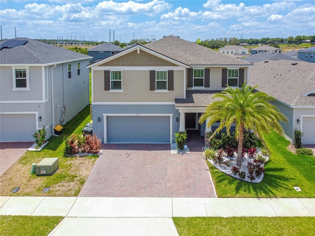 2227 Blue Salvia St, Clermont, FL 34711 - view of front of home featuring decorative driveway, a garage, a residential view, and a front lawn