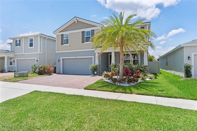 2227 Blue Salvia St, Clermont, FL 34711 - view of front of house featuring a garage, decorative driveway, stucco siding, and a front yard