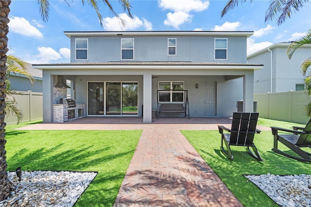 2227 Blue Salvia St, Clermont, FL 34711 - rear view of property featuring stucco siding, an outdoor kitchen, a patio area, and stone siding