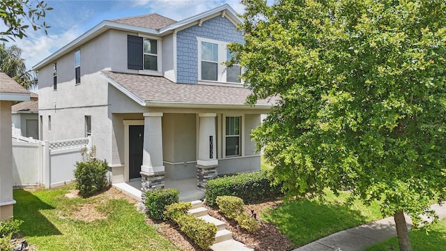 10172 Storey Grove Way, Winter Garden, FL 34787 - view of front of home with a shingled roof, stucco siding, and covered porch
