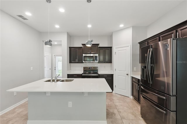 10172 Storey Grove Way, Winter Garden, FL 34787 - kitchen featuring appliances with stainless steel finishes, light countertops, an island with sink, recessed lighting, and light tile patterned floors