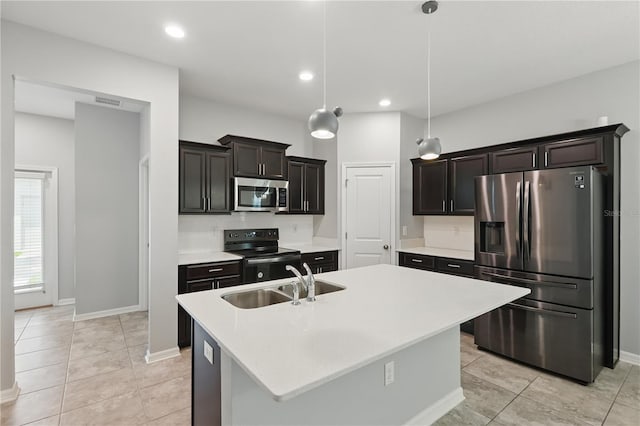 10172 Storey Grove Way, Winter Garden, FL 34787 - kitchen featuring stainless steel appliances, a sink, light countertops, baseboards, and a center island with sink