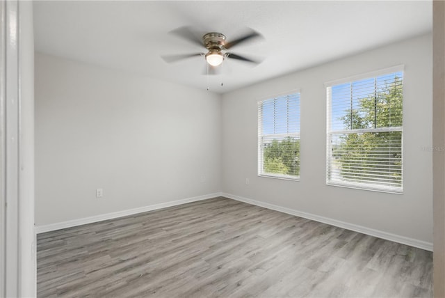 10172 Storey Grove Way, Winter Garden, FL 34787 - spare room featuring wood finished floors, a ceiling fan, and baseboards