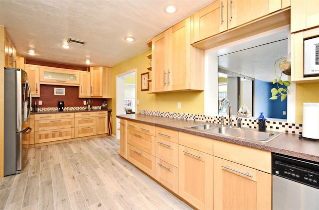 2810 Nancy St, Orlando, FL 32806 - kitchen featuring light brown cabinetry, stainless steel appliances, a sink, recessed lighting, and light wood-style floors