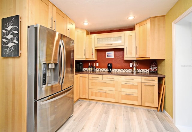 2810 Nancy St, Orlando, FL 32806 - kitchen featuring stainless steel fridge, light brown cabinets, dark countertops, light wood finished floors, and recessed lighting