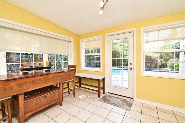 2810 Nancy St, Orlando, FL 32806 - doorway to outside featuring light tile patterned floors, baseboards, and track lighting