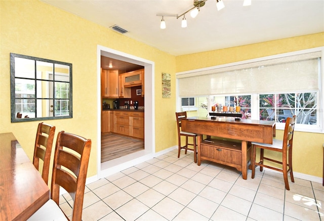 2810 Nancy St, Orlando, FL 32806 - dining room featuring healthy amount of natural light, baseboards, and light tile patterned floors