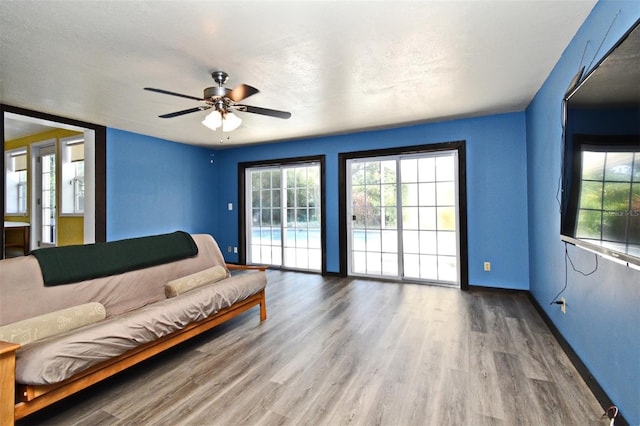 2810 Nancy St, Orlando, FL 32806 - living room featuring a ceiling fan, wood finished floors, and baseboards