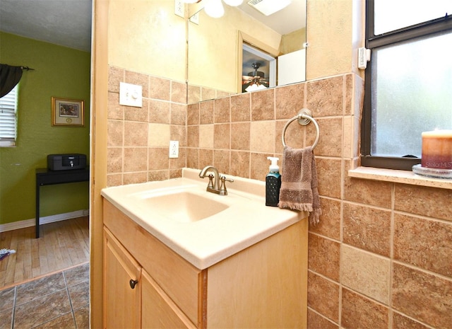 2810 Nancy St, Orlando, FL 32806 - bathroom with tile walls, vanity, plenty of natural light, and ceiling fan