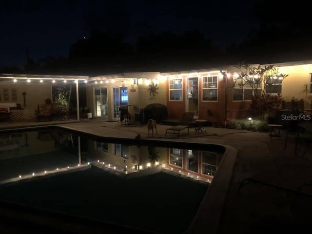 2810 Nancy St, Orlando, FL 32806 - pool at night with a patio area and an outdoor pool