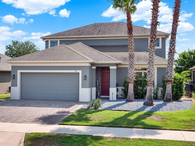 987 Nathan Ridge Rd, Clermont, FL 34715 - traditional home with stucco siding, a garage, driveway, and a front lawn